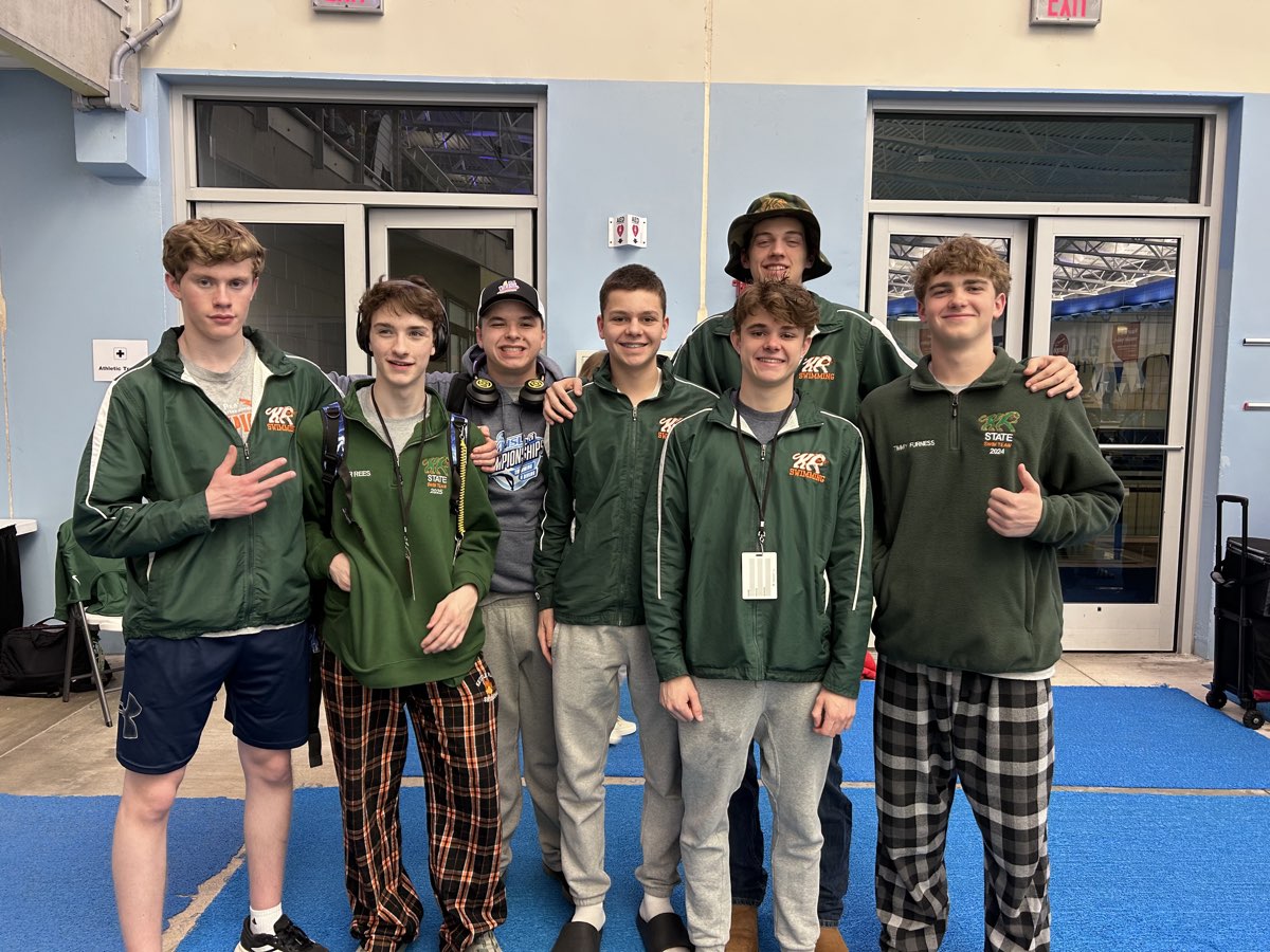 A group of Kettle Run boys in team jackets on the pool deck